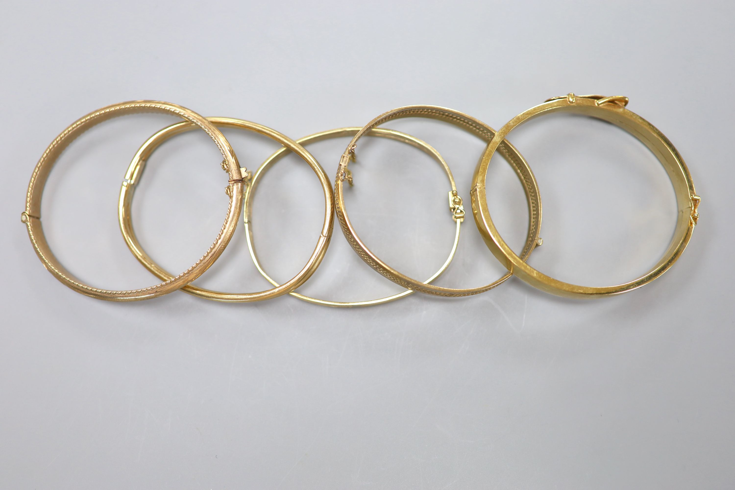 Five assorted modern 9ct gold hinged bangles